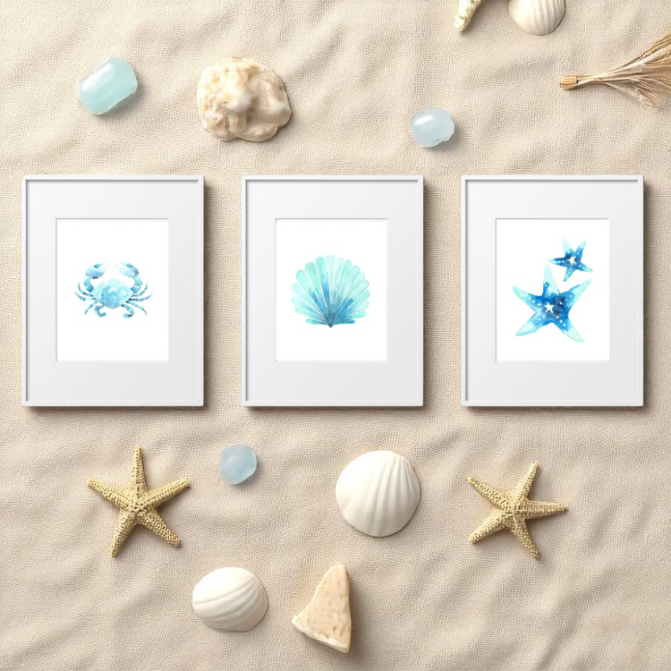 Flat lay of coastal watercolor art prints featuring seashells, starfish, coral, and sea horses on white wood background — 8x10 unframed beach wall art