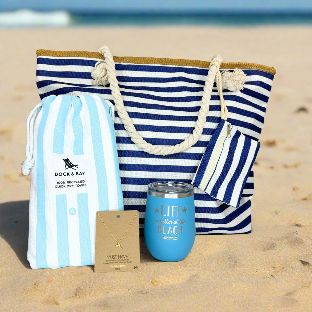 Beach Lover Gift Set featuring a navy and white striped beach bag, 18k gold dolphin necklace, insulated tumbler, and quick-dry sand-free beach towel