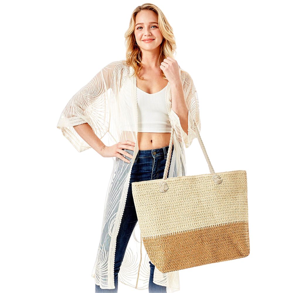woman carrying beige, tan, straw beach bag tote with rope handles