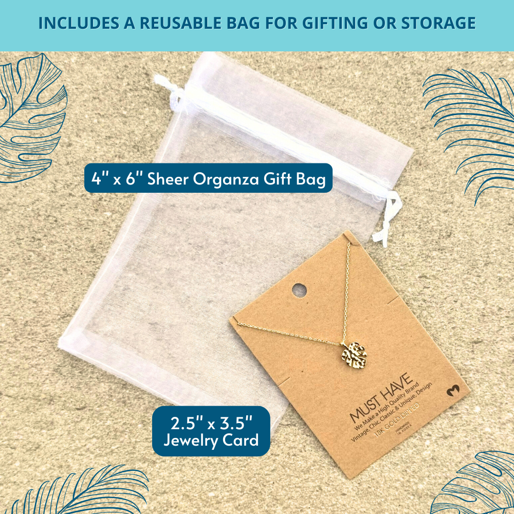 18k gold dipped monstera leaf necklace shown with white organza bag – includes reusable bag for gifting or everyday storage