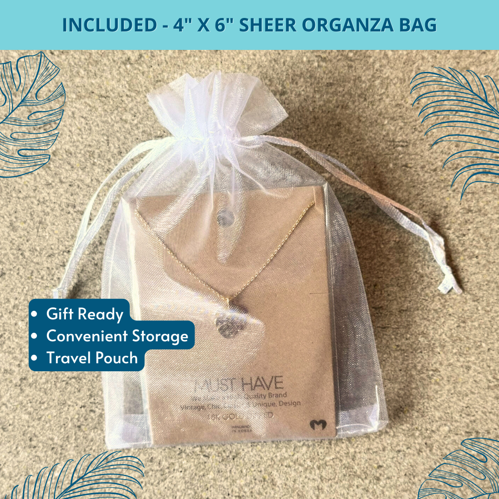 Gold monstera necklace in organza gift bag with ribbon, styled as a thoughtful beach lover gift for women.