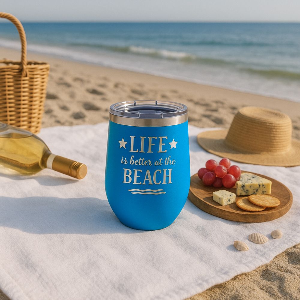 ocean blue metal wine tumbler with a beach picnic with wine and cheese