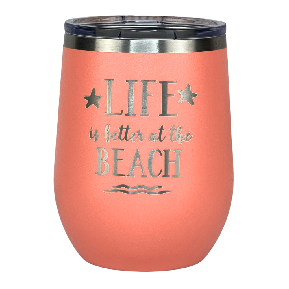 Close-up view of the peach tumbler showing the engraved "Life is Better at the Beach" design.