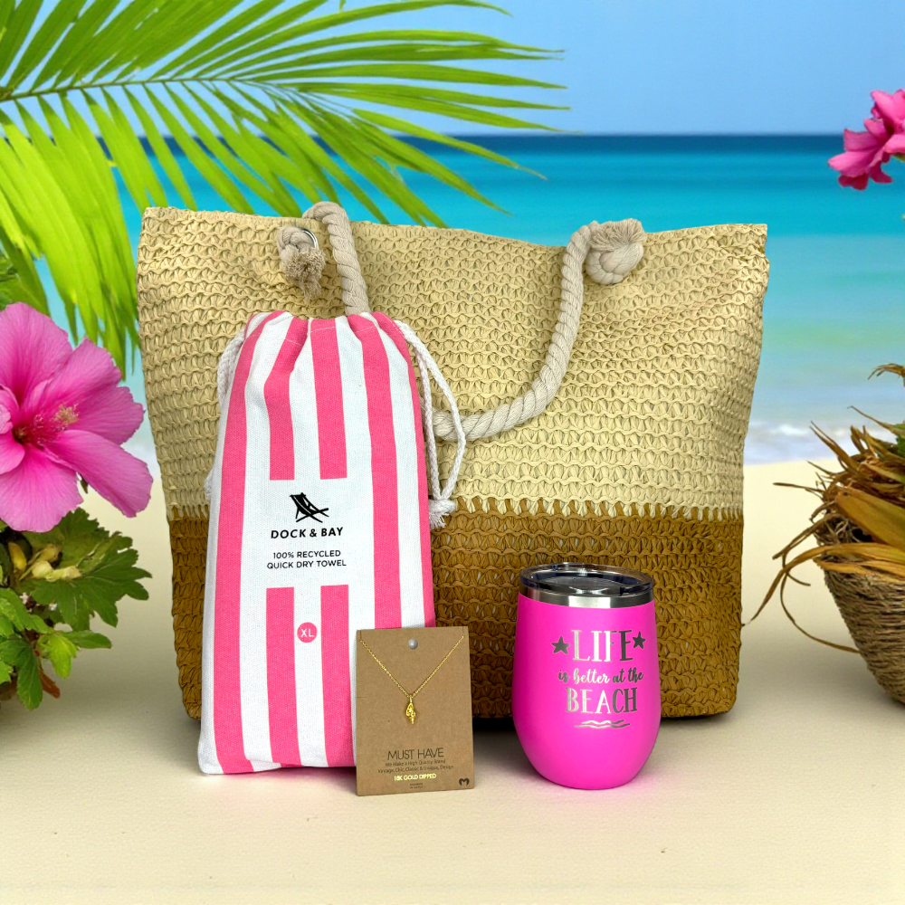 Beach Lover Gift Set Idea for Her including a straw bag, striped towel, and pink tumbler with ocean and palm tree background.