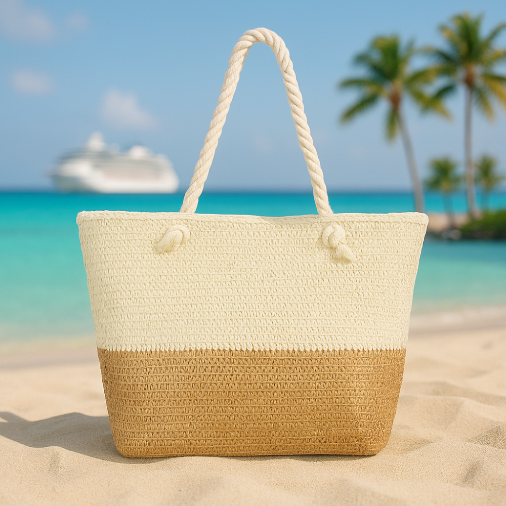 oversized straw beach bag on a sandy beach with palm trees and a cruise ship in the background.