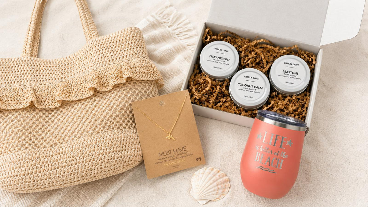 Gifts for beach lovers flat lay — beach bag, gold necklace, candle trio, and wine tumbler from Breezy Cove