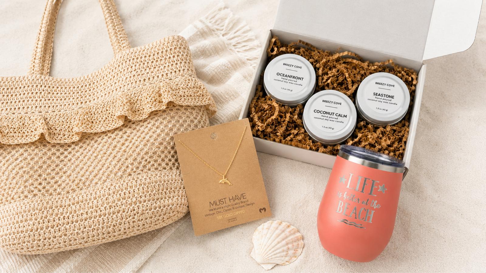 Gifts for beach lovers flat lay — beach bag, gold necklace, candle trio, and wine tumbler from Breezy Cove