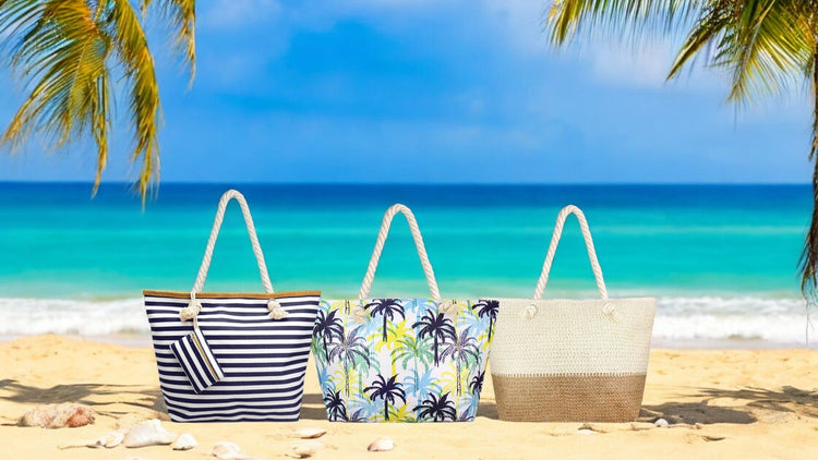 oversize beach bag collection on a sandy beach, navy and white strip, palm trees and straw bags