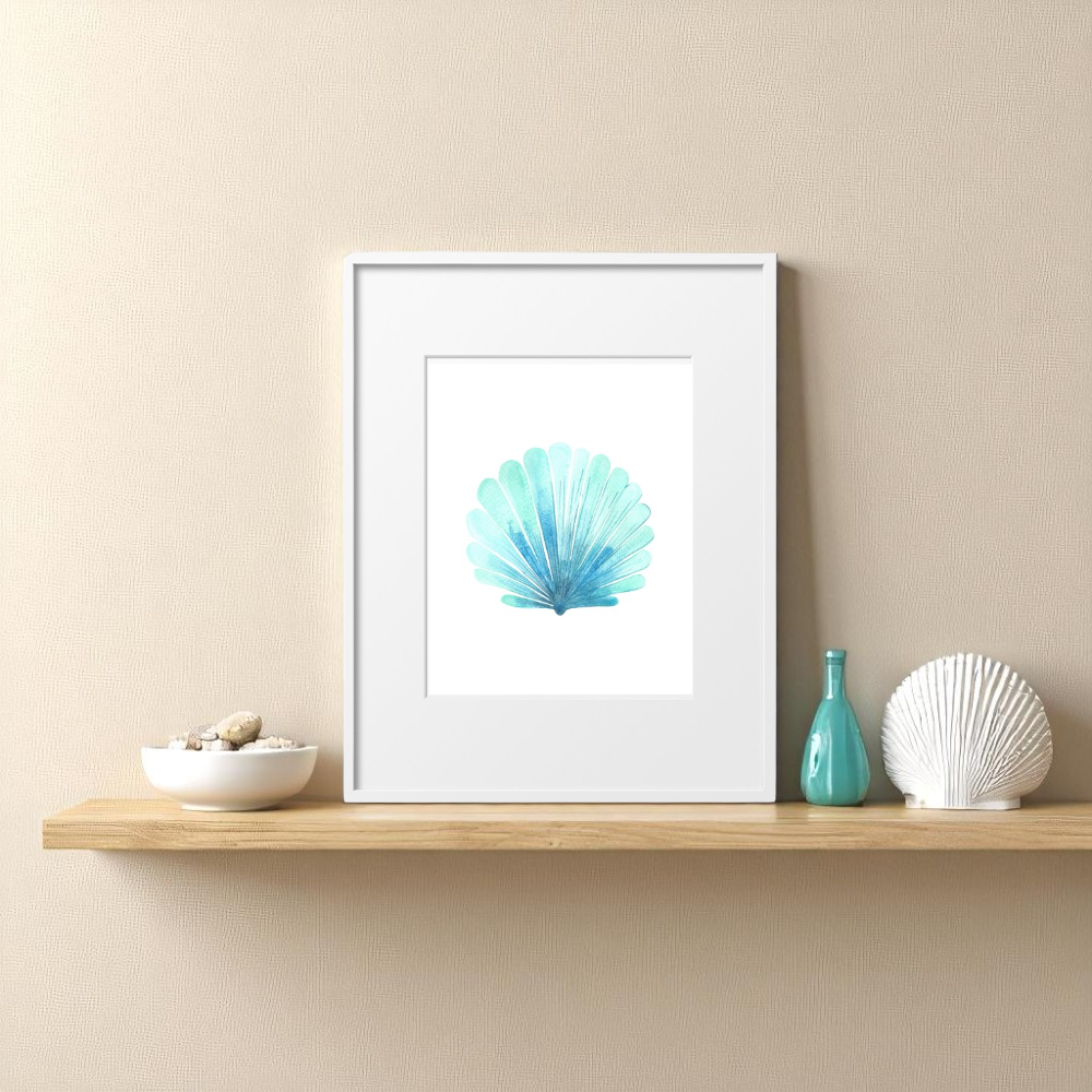 Single 8x10 framed seashell art print leaning on a floating shelf with coastal decor, including a ceramic bowl of beach pebbles, a white coral accent, and a turquoise glass bottle, styled against a soft beige wall.