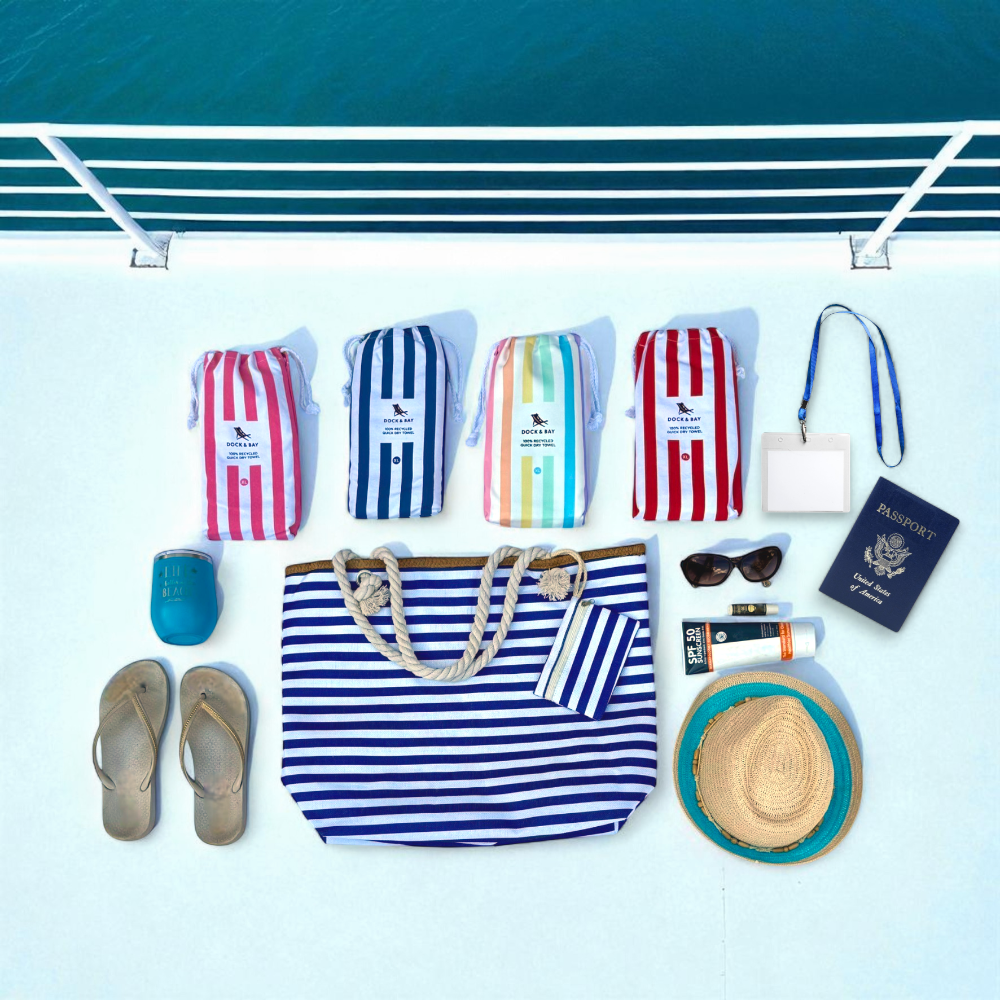 Navy and white striped beach tote bag shown in flat lay style on cruise ship deck with soft natural lighting