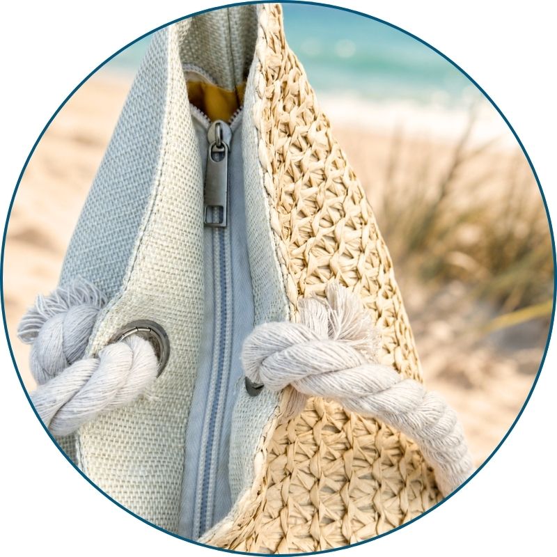 Straw beach bags with zipper keeping towels, sunscreen, and other beach essentials secure and easy to reach.