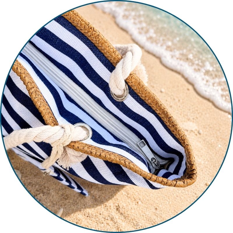 Navy and white striped beach bag with zippered top shown zipped from a top down view.