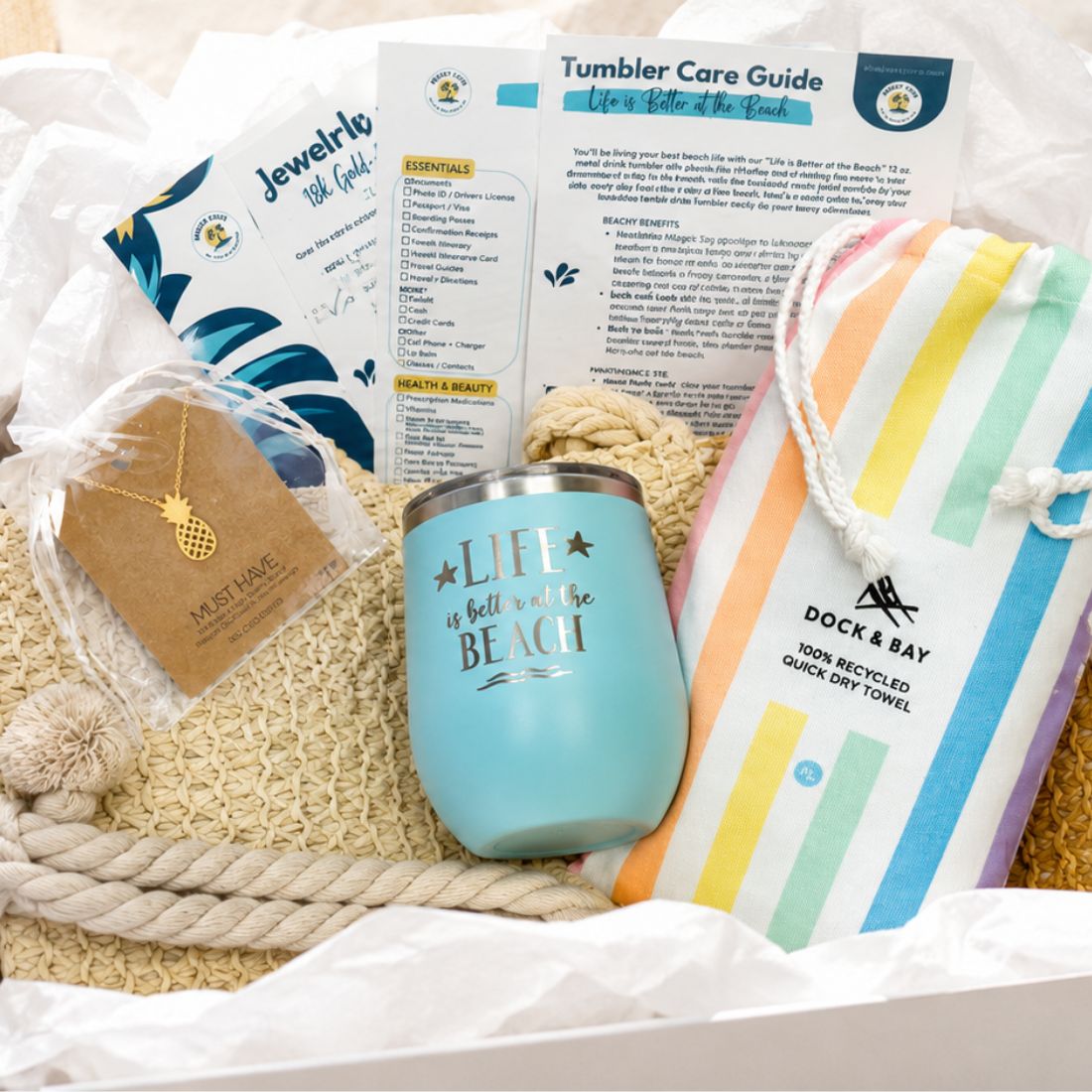 unique gifts for beach lovers with pastel beach lover gift set including straw beach bag with zipper, pineapple pendant necklace, pastel beach towel and metal beach tumbler