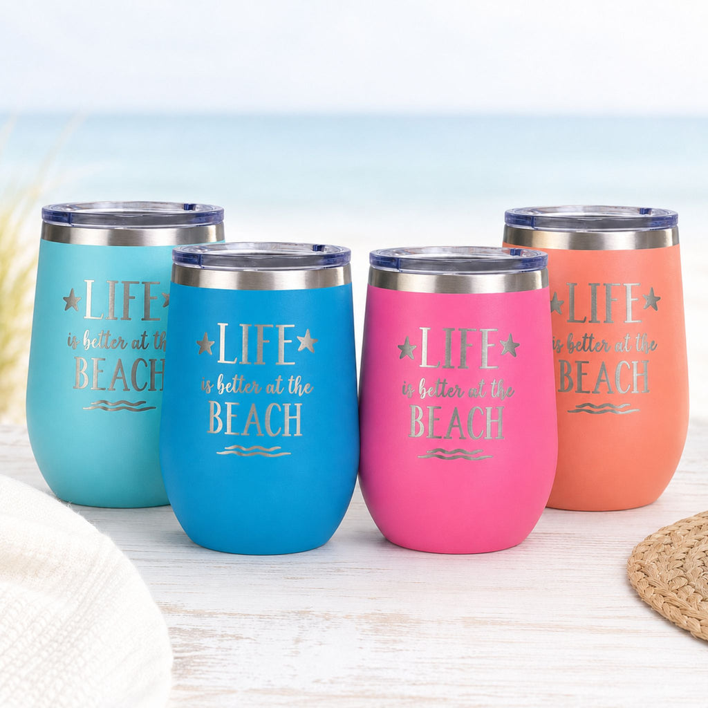 Beach insulated wine tumblers with lids in teal, ocean blue, pink, and peach on a light coastal background