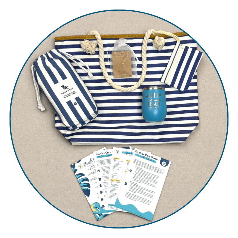 Flat lay of Navy Nautical Beach Lover Gift Set with striped beach bag, navy towel, ocean blue tumbler, sea turtle necklace, and bonus cards.