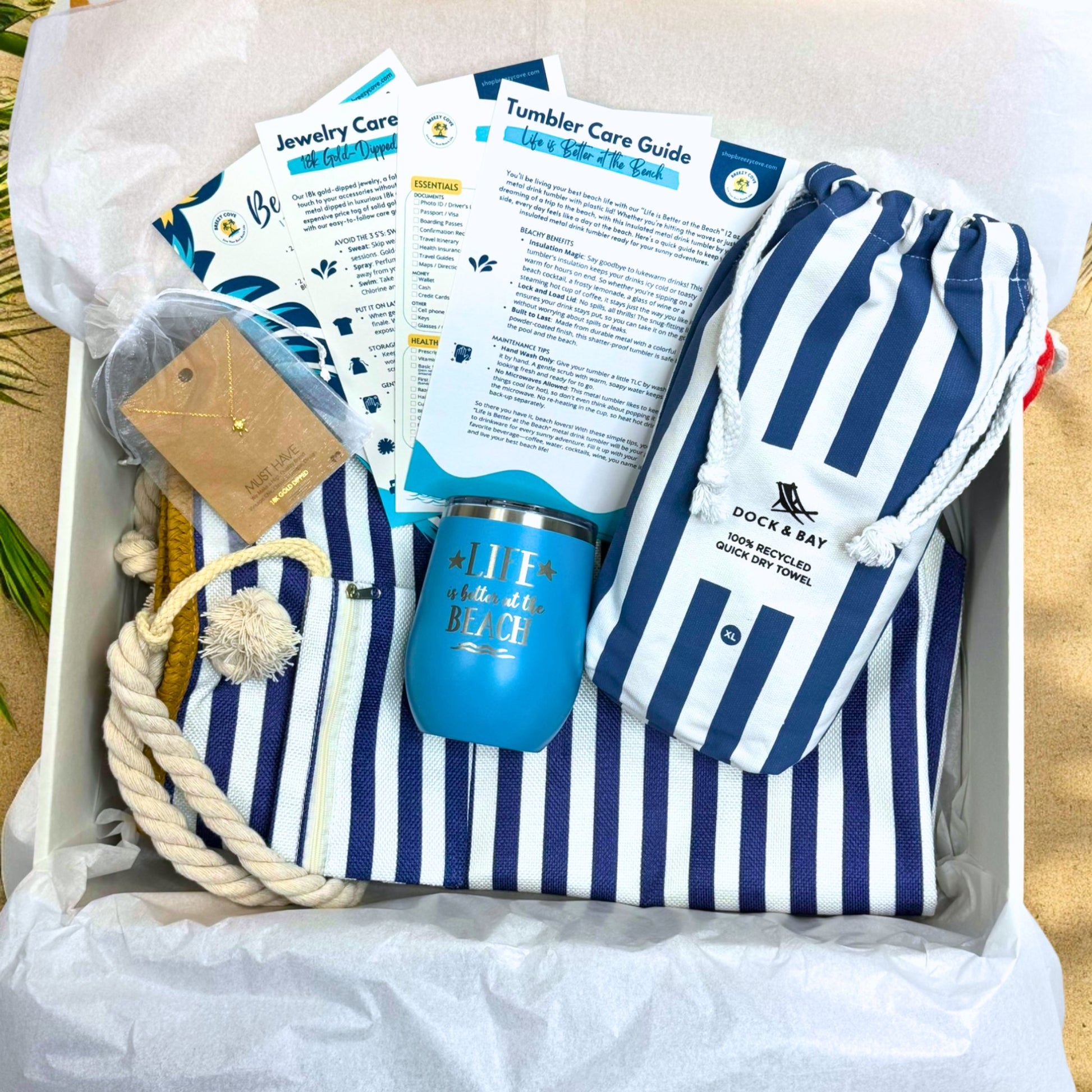 Navy Nautical Beach Lover Beach Bag Gift Set with striped towel, ocean blue tumbler, gold sea turtle necklace, and printed bonus cards in gift box.