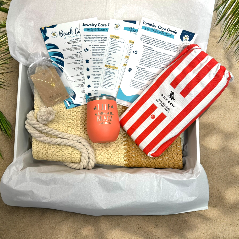 Coral Beach Lover Gift Set with coral striped towel, peach tumbler, gold monstera necklace, and printed bonus cards in Breezy Cove gift box.