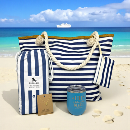 Navy Beach Lover Gift Set arranged on natural sand with turquoise ocean and cruise ship in the distance. A beautiful, ready-to-gift beach lover gift set perfect for beach vacations, cruise gifts, or thoughtful gifts for beach lovers any time of year.
