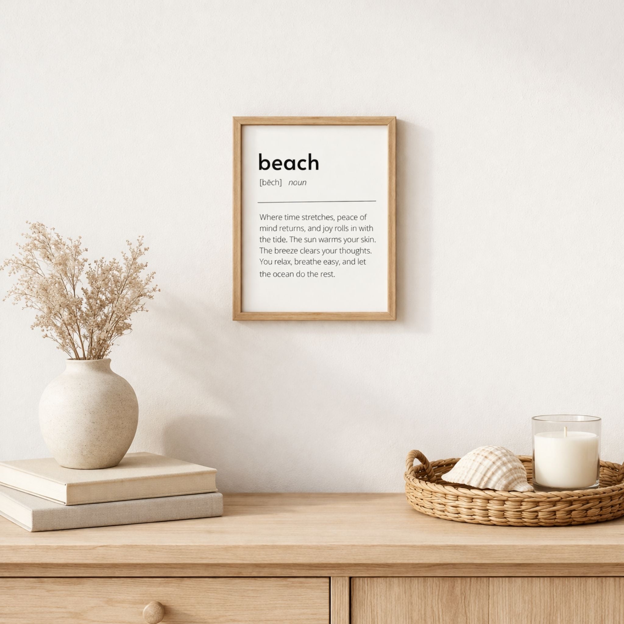 Minimalist beach definition art print styled above a light wood table with neutral coastal decor