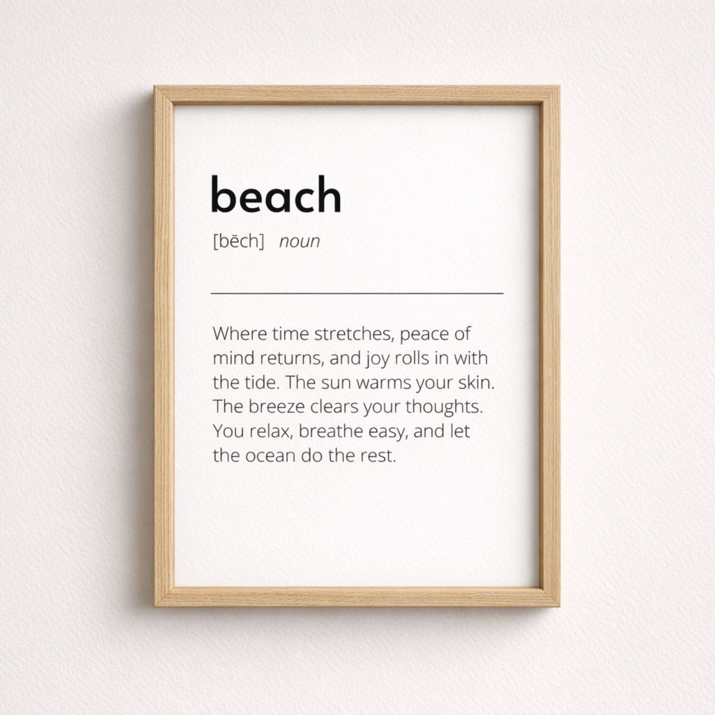 Beach definition art print in light wood frame with minimalist black text on white background