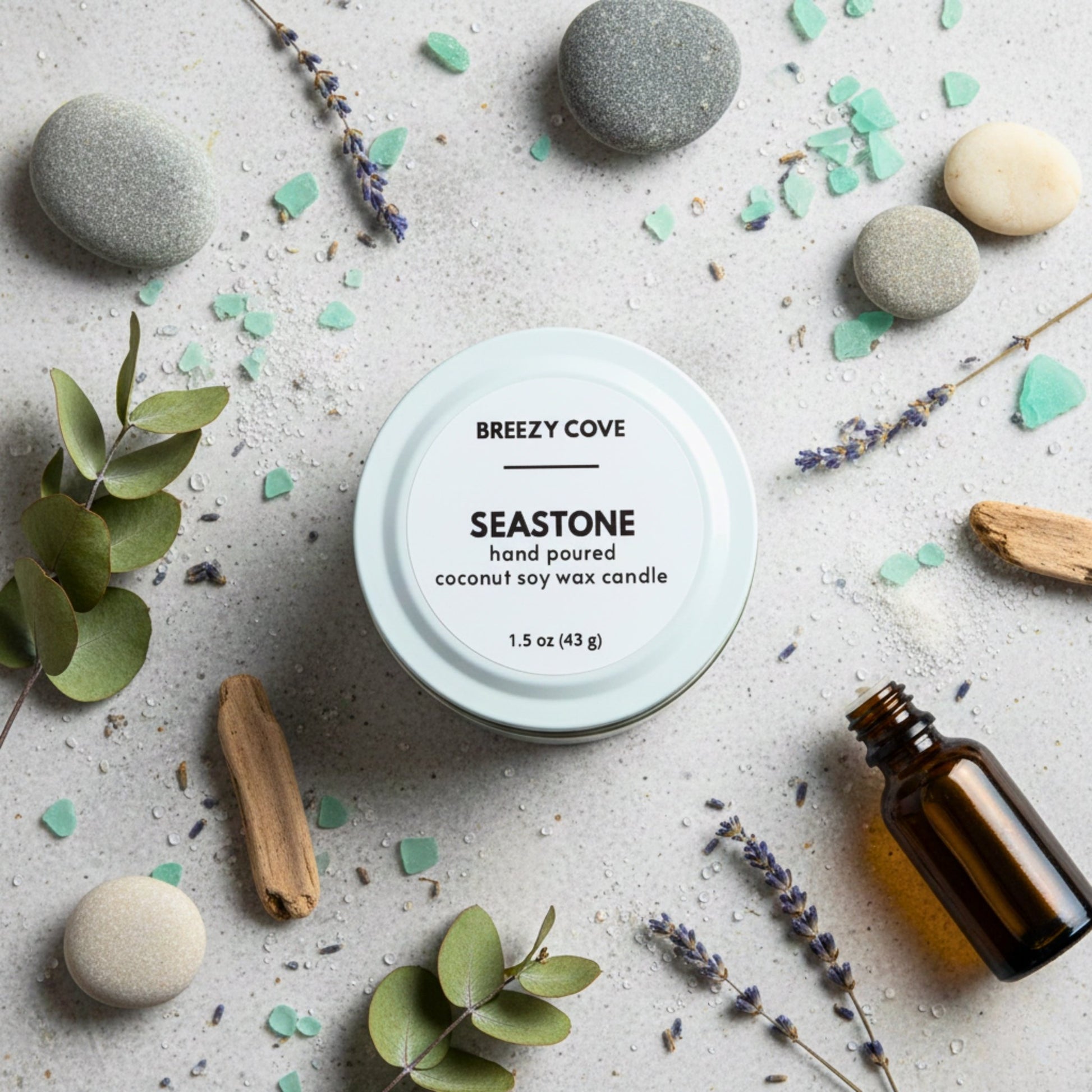 Seastone beach themed mini candle with sea glass, stones, and botanicals for a calm coastal scent.