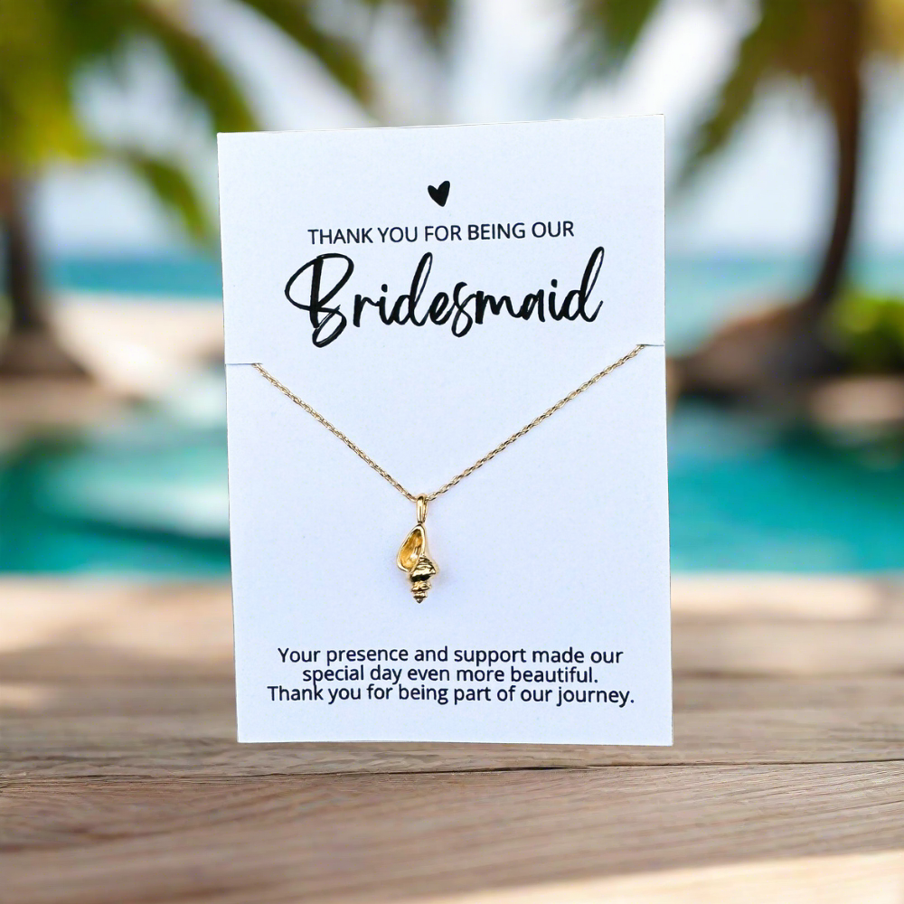 an 18k gold dipped conch shell necklace on a bridesmaid thank you card for an affordable bridal party gift for beach wedding