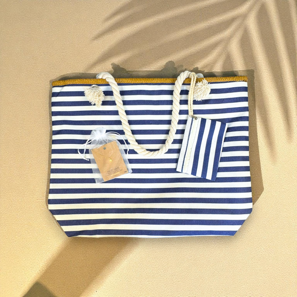 Navy striped beach bag with gold sea turtle necklace on soft sandy background with palm shadows — Breezy Cove Best Seller Bundle for women who love effortless coastal style.