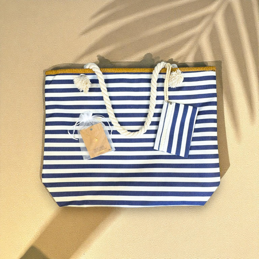 Navy striped beach bag with gold sea turtle necklace on soft sandy background with palm shadows — Breezy Cove Best Seller Bundle for women who love effortless coastal style.