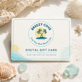 Breezy Cove digital gift card for beach lovers on a coastal flat lay