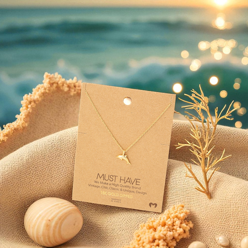 18k gold dipped dolphin necklace styled with beach-inspired accents for women who love the ocean.