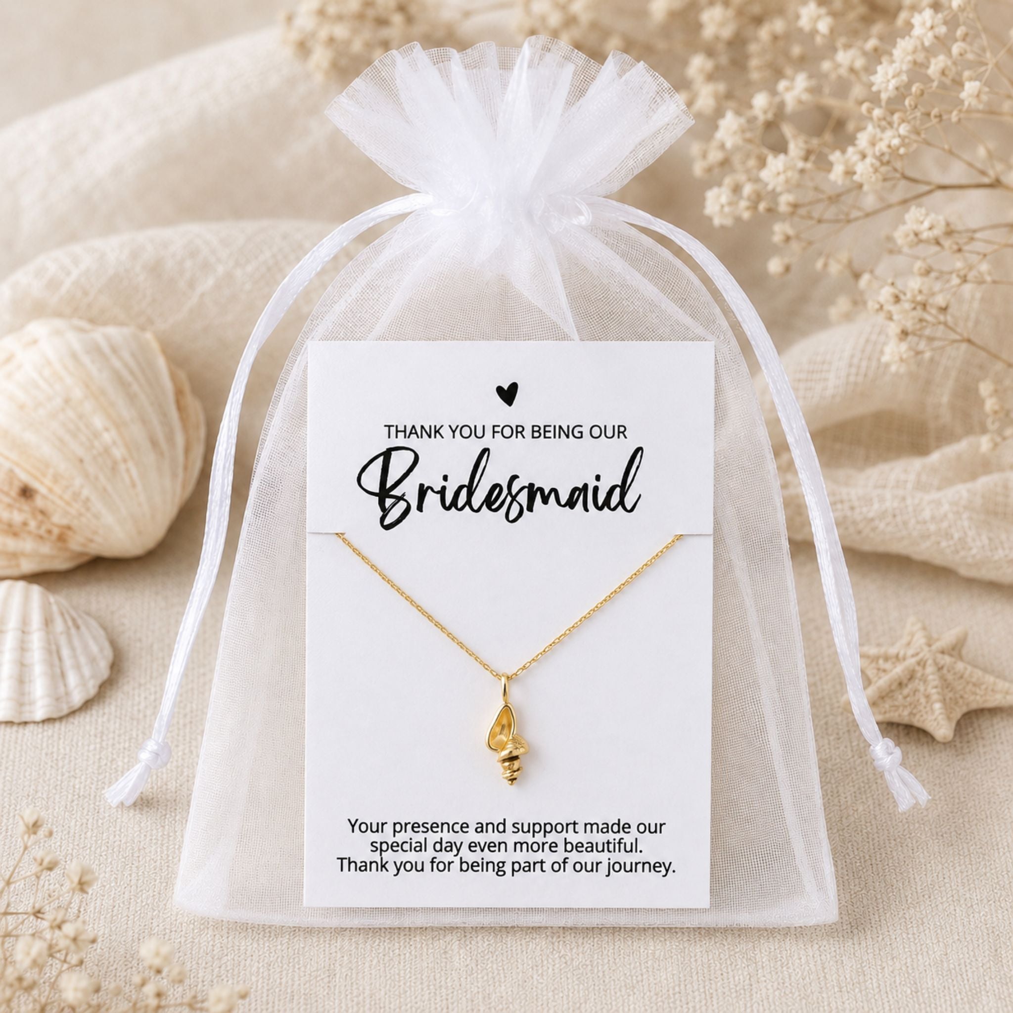 Bridesmaid conch shell necklace gift packaged in a white organza bag for a beach wedding