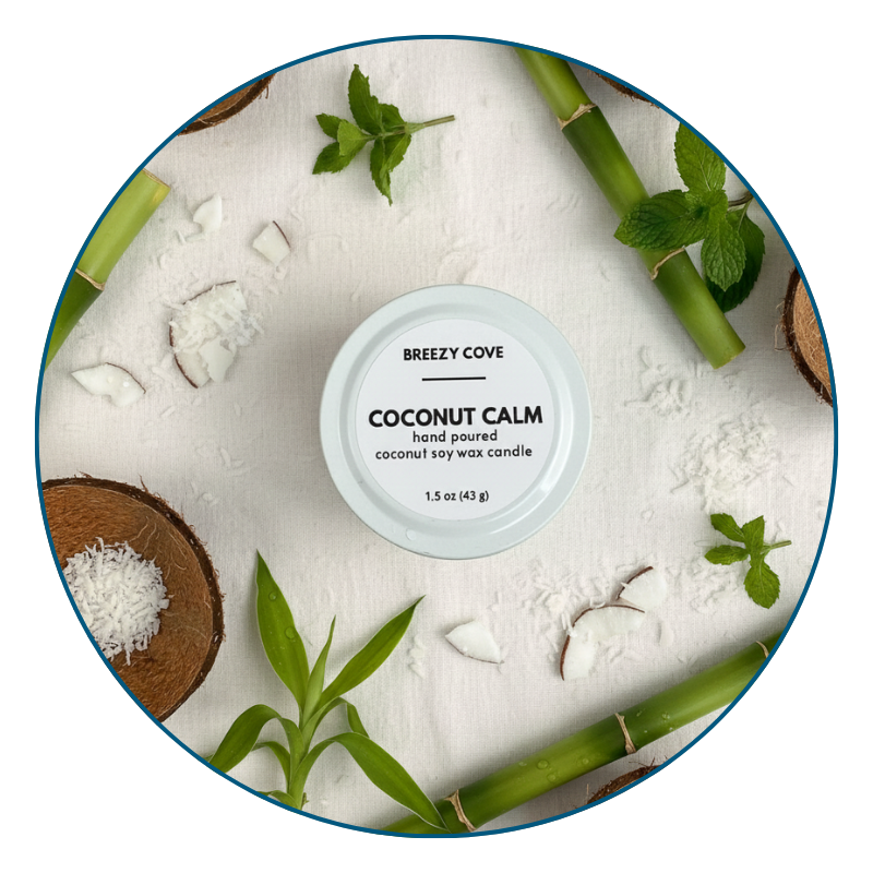 Coconut Calm coconut beach candle scent surrounded by coconut pieces, bamboo, and fresh mint.
