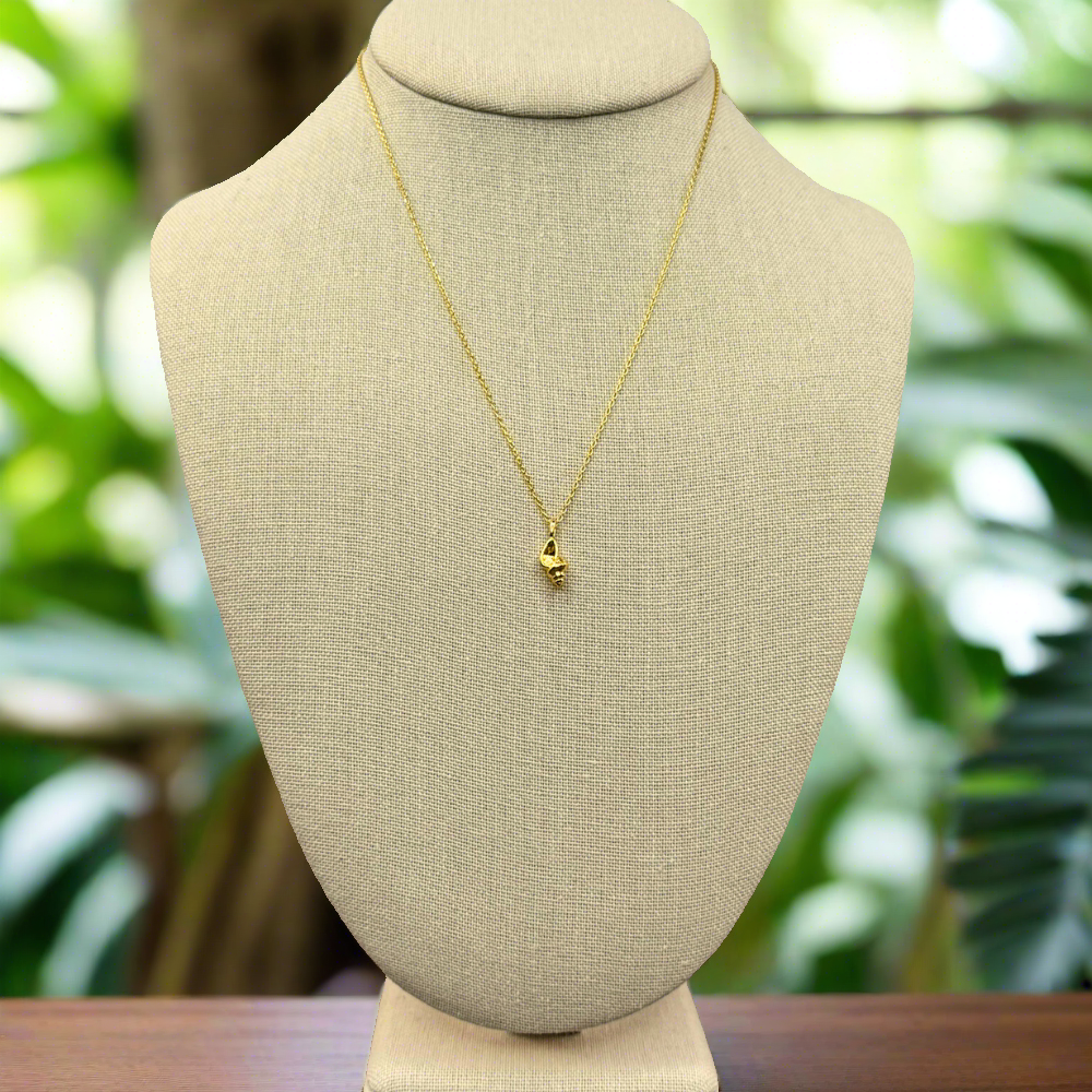 dainty, conch pendant necklace 18k gold dipped necklace is perfect jewelry accessory for beach lovers on linen jewelry display with tropical backdrop