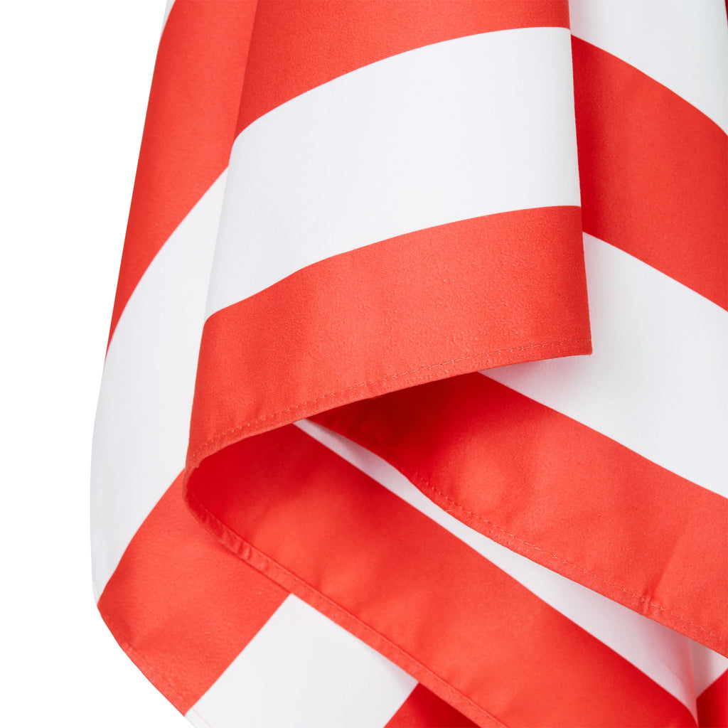 Close-up of coral striped microfiber beach towel fabric and edge detail
