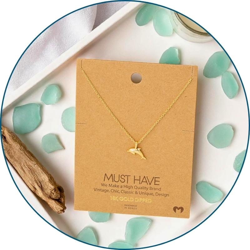 Gold dolphin necklace on jewelry card with white organza gift bag — 18k gold dipped beach necklace ready to gift
