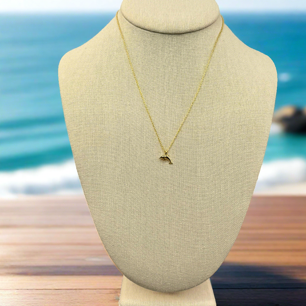 dainty, dolphin pendant necklace 18k gold dipped necklace is perfect jewelry accessory for beach lovers on linen jewelry display