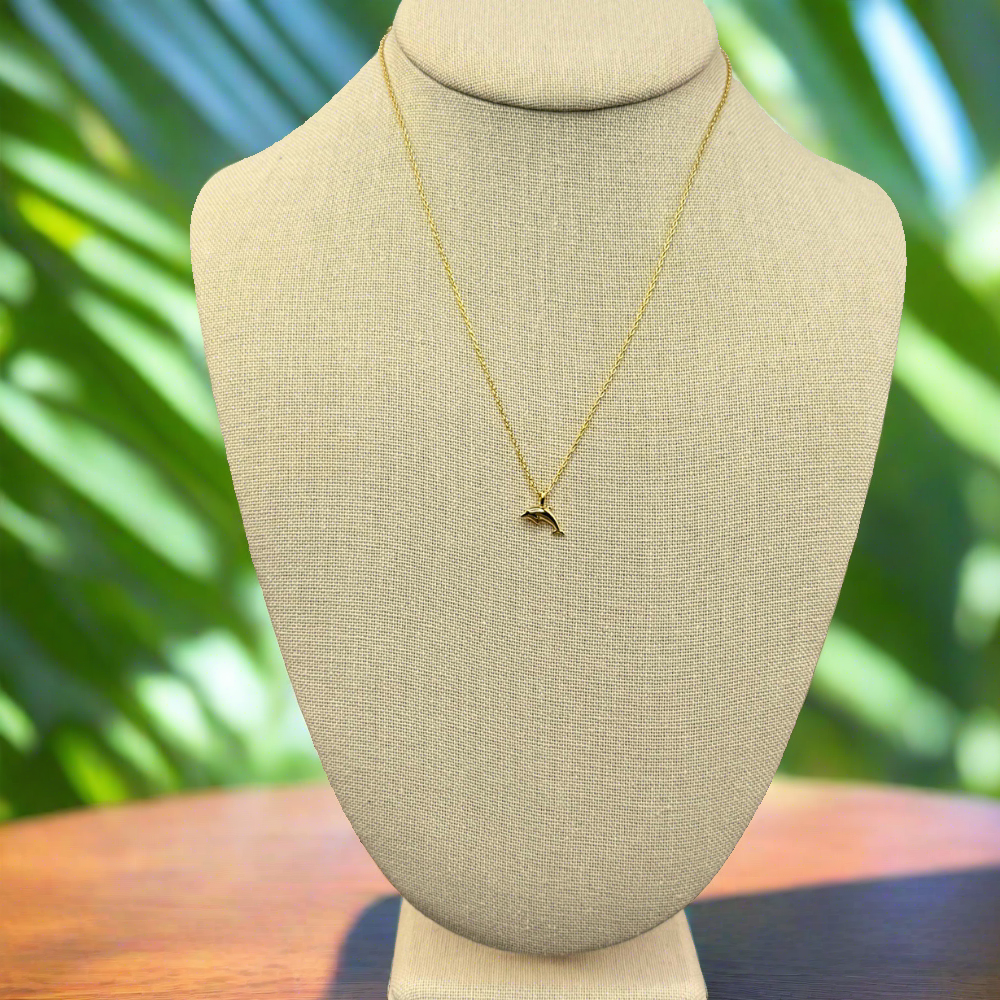 dainty, dolphin pendant necklace 18k gold dipped necklace is perfect jewelry accessory for beach lovers on linen jewelry display