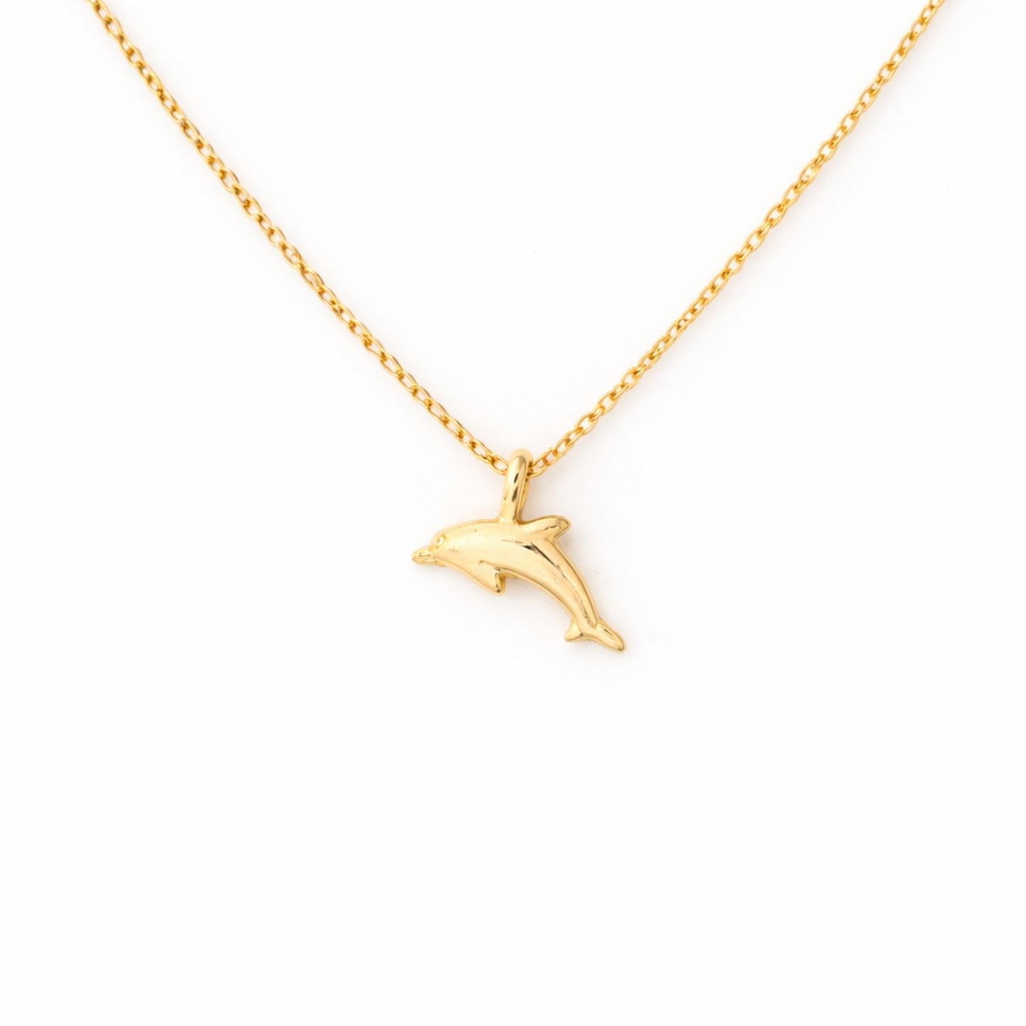 Detailed close-up of the 18k gold-dipped dolphin pendant necklace, highlighting its sleek design and shimmering finish