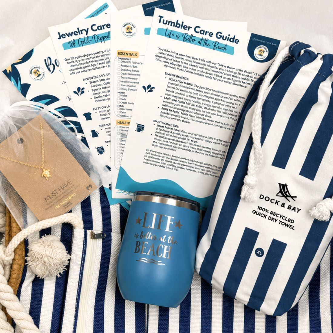 Navy beach gift set for beach lovers with striped beach bag, navy striped quick dry towel, blue tumbler, and gold dipped sea turtle necklace packaged in a gift box with tissue paper