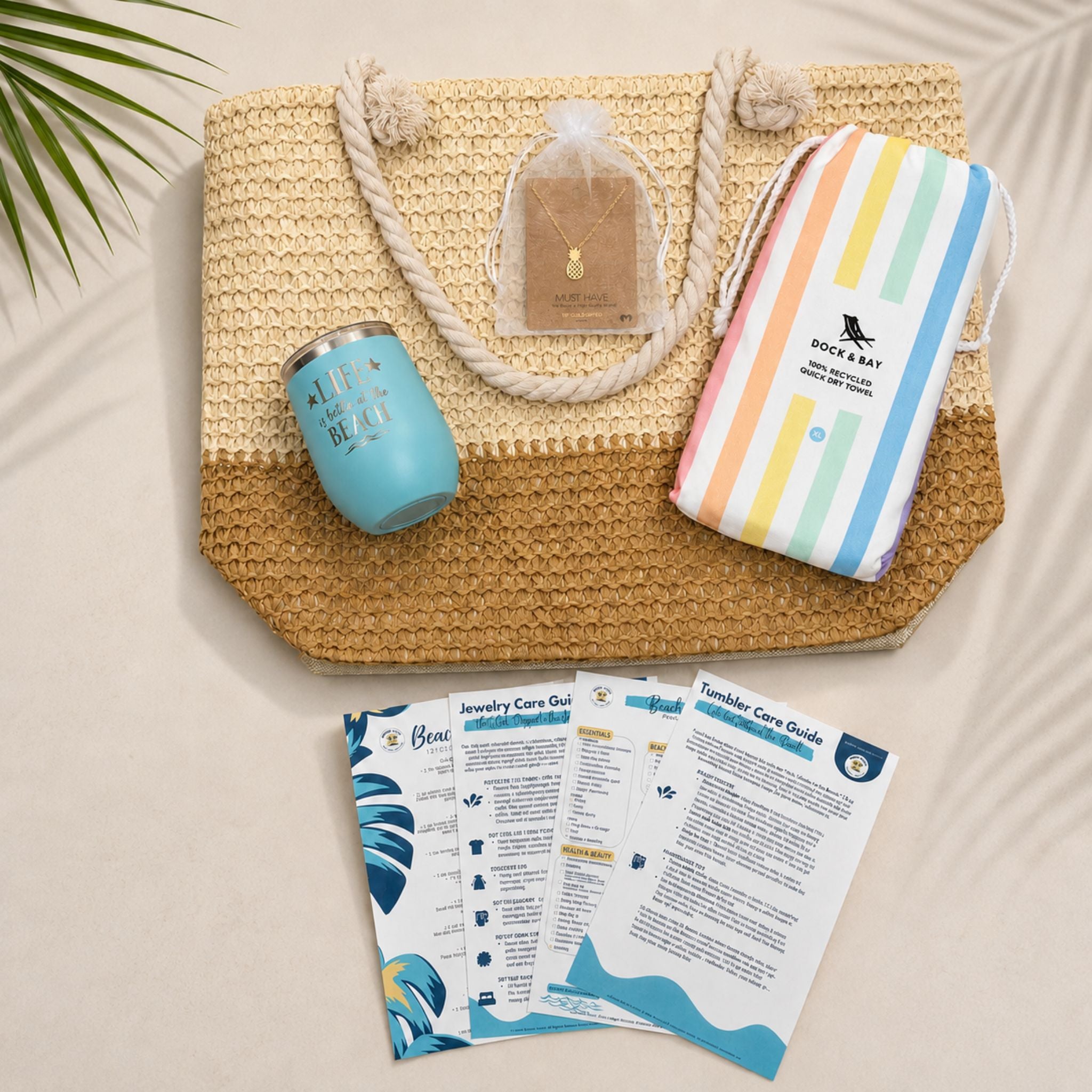 Unique gift for beach lovers showing a flat lay of Pastel Beach Lover Gift Set with straw beach bag with zipper, pastel striped towel, teal tumbler, pineapple necklace, and printed bonuses.