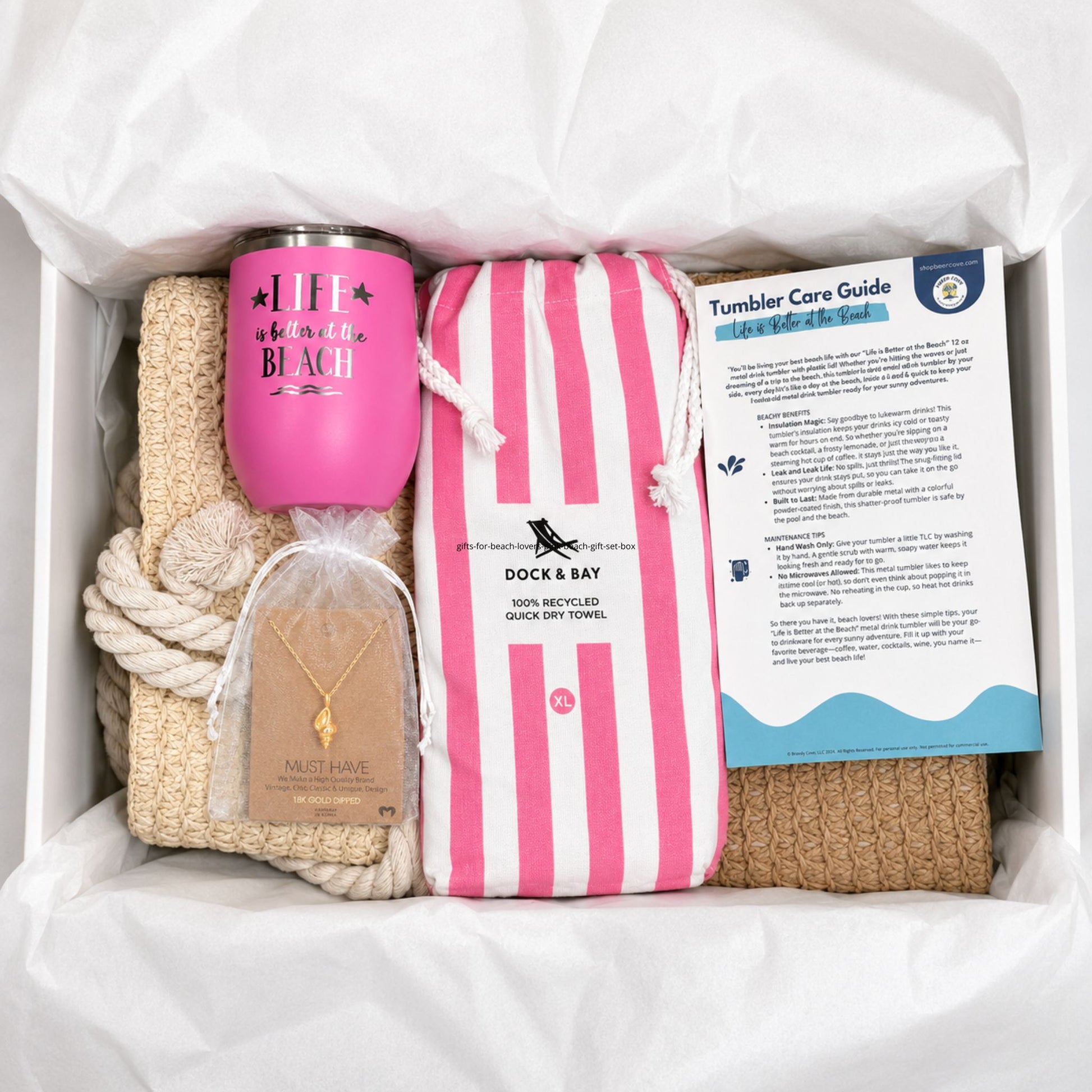 Pink beach gift set for beach lovers with straw beach bag, pink quick dry towel, pink tumbler, conch shell necklace, and care cards packaged in a gift box with tissue paper.