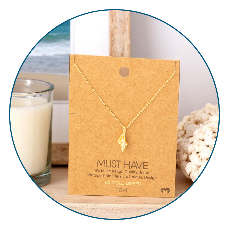 Dainty gold conch shell necklace on beach vanity styled for everyday wear with coastal-inspired accents.