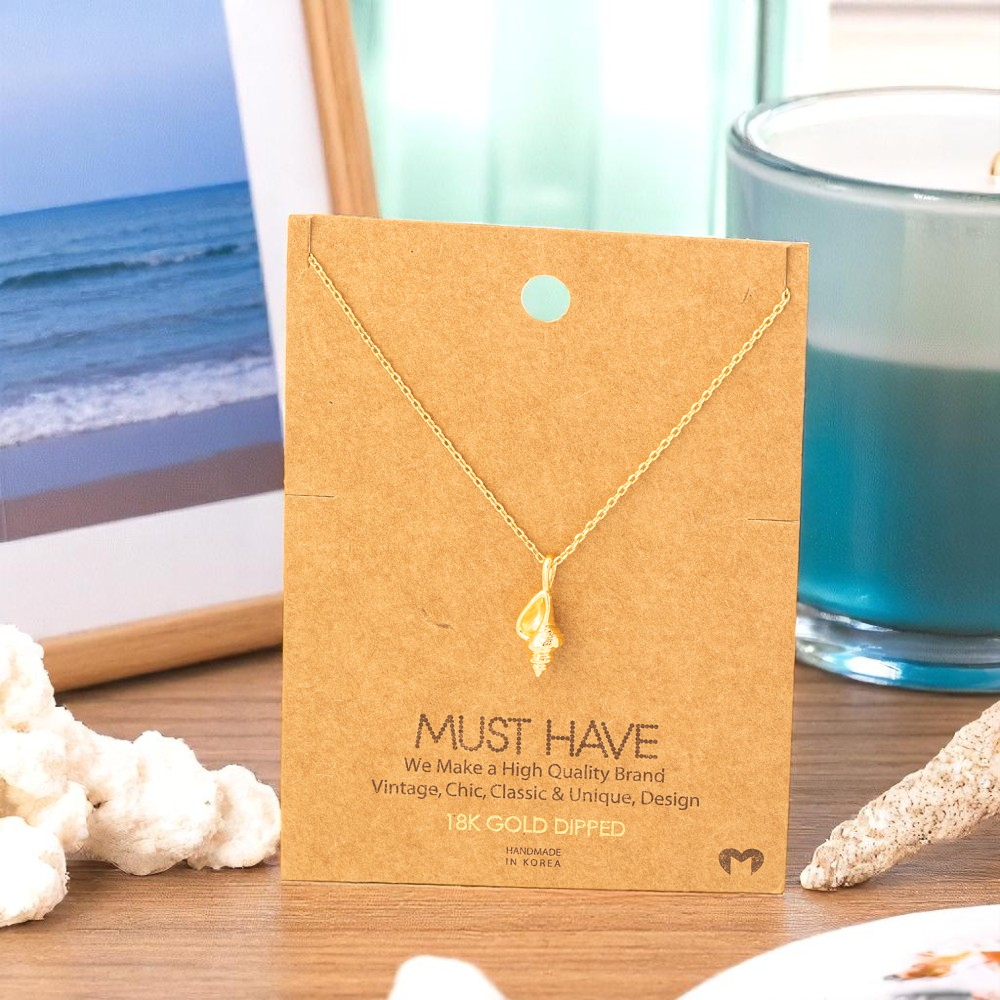 18k gold dipped conch shell necklace styled with coastal-inspired accents for women who love the ocean.