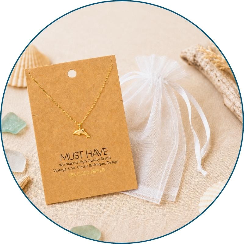 Gold dolphin necklace with a white organza gift bag — 18k gold dipped dolphin pendant necklace ready to gift