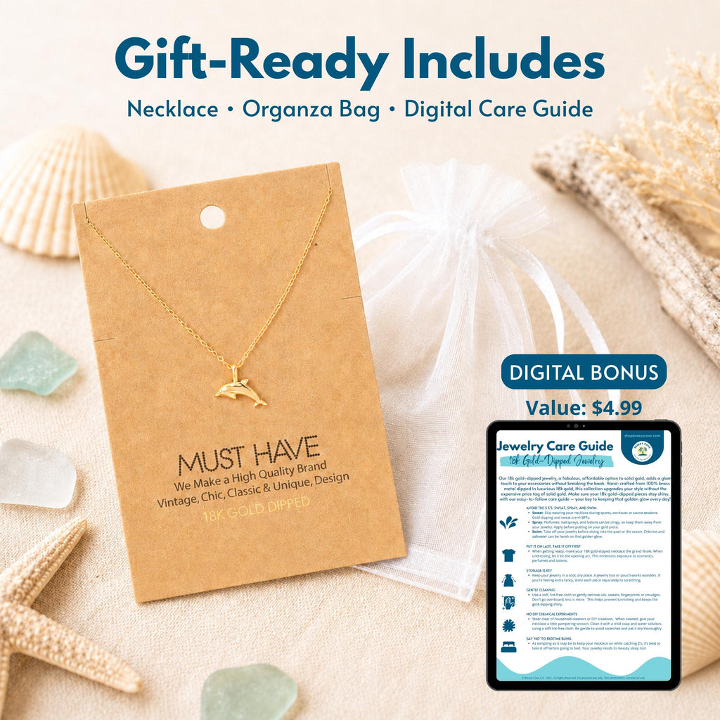 Gold dolphin necklace gift set — includes 18k gold dipped dolphin necklace on jewelry card, white organza bag, and digital jewelry care guide