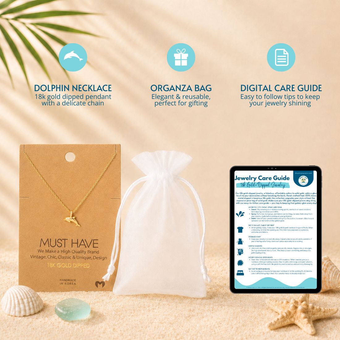 What's included with the gold dolphin necklace — 18k gold dipped dolphin necklace on jewelry card, white organza gift bag, and digital jewelry care guide
