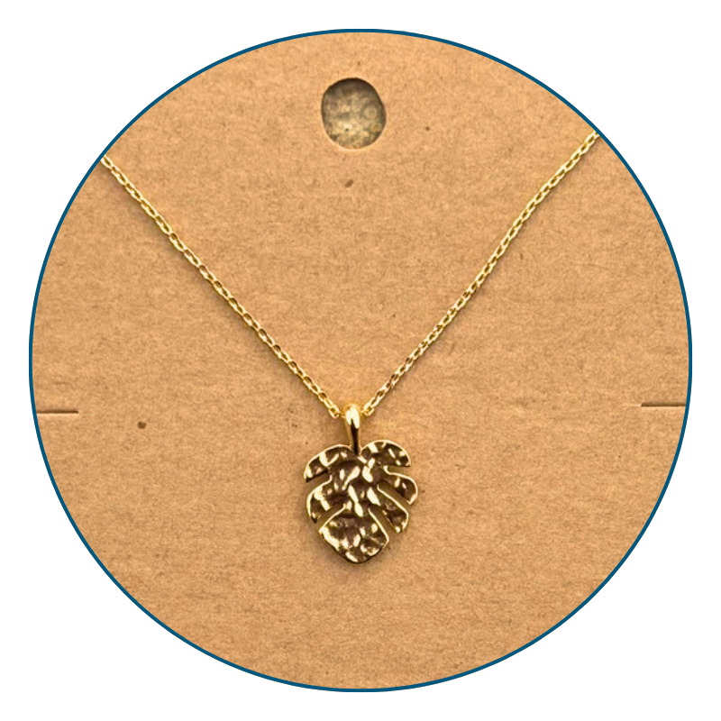 Close-up of 18k gold dipped monstera necklace pendant with polished golden shine and detailed leaf design.