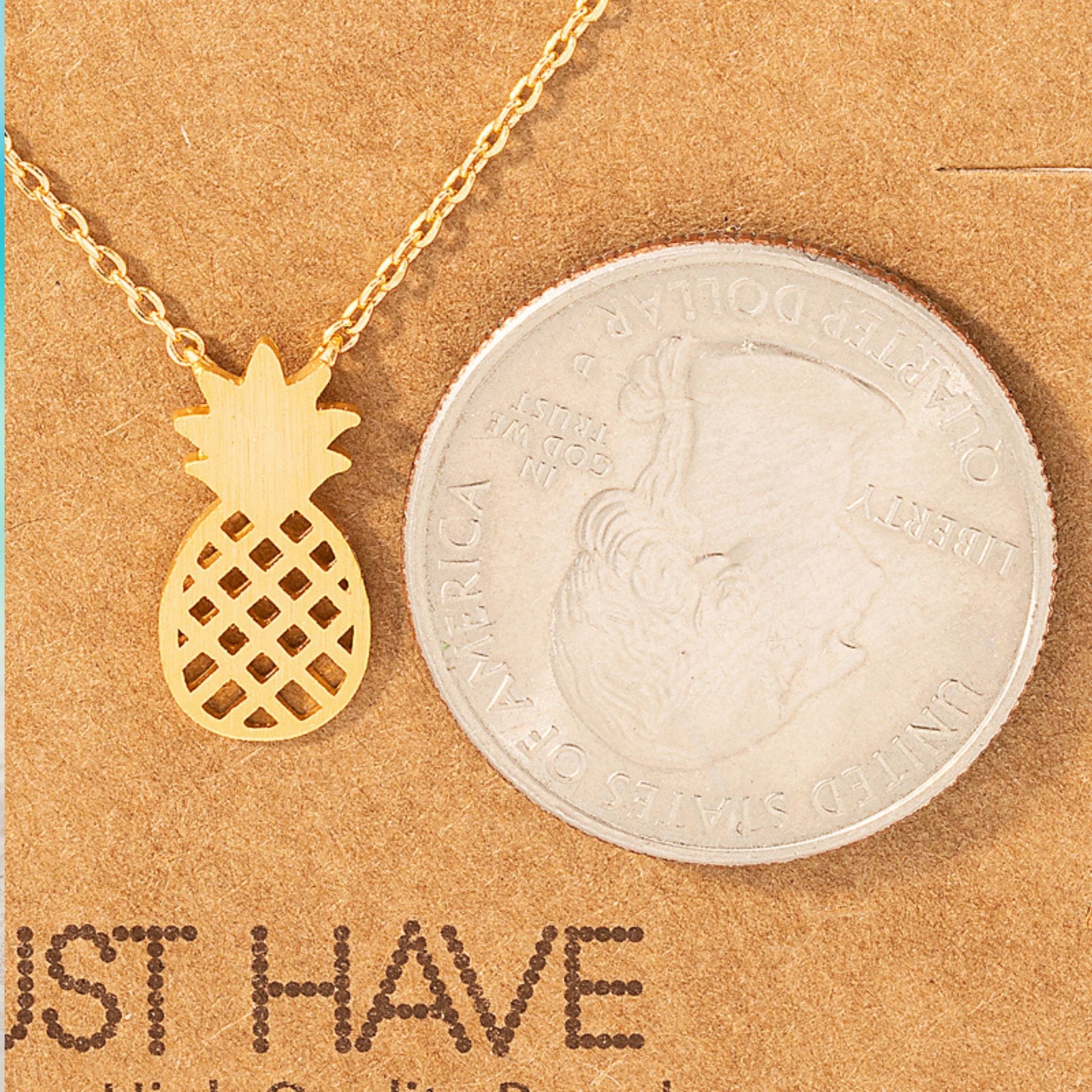 pineapple pendant necklace in 18k gold – perfect for beach lovers showing dainty size next to a quarter