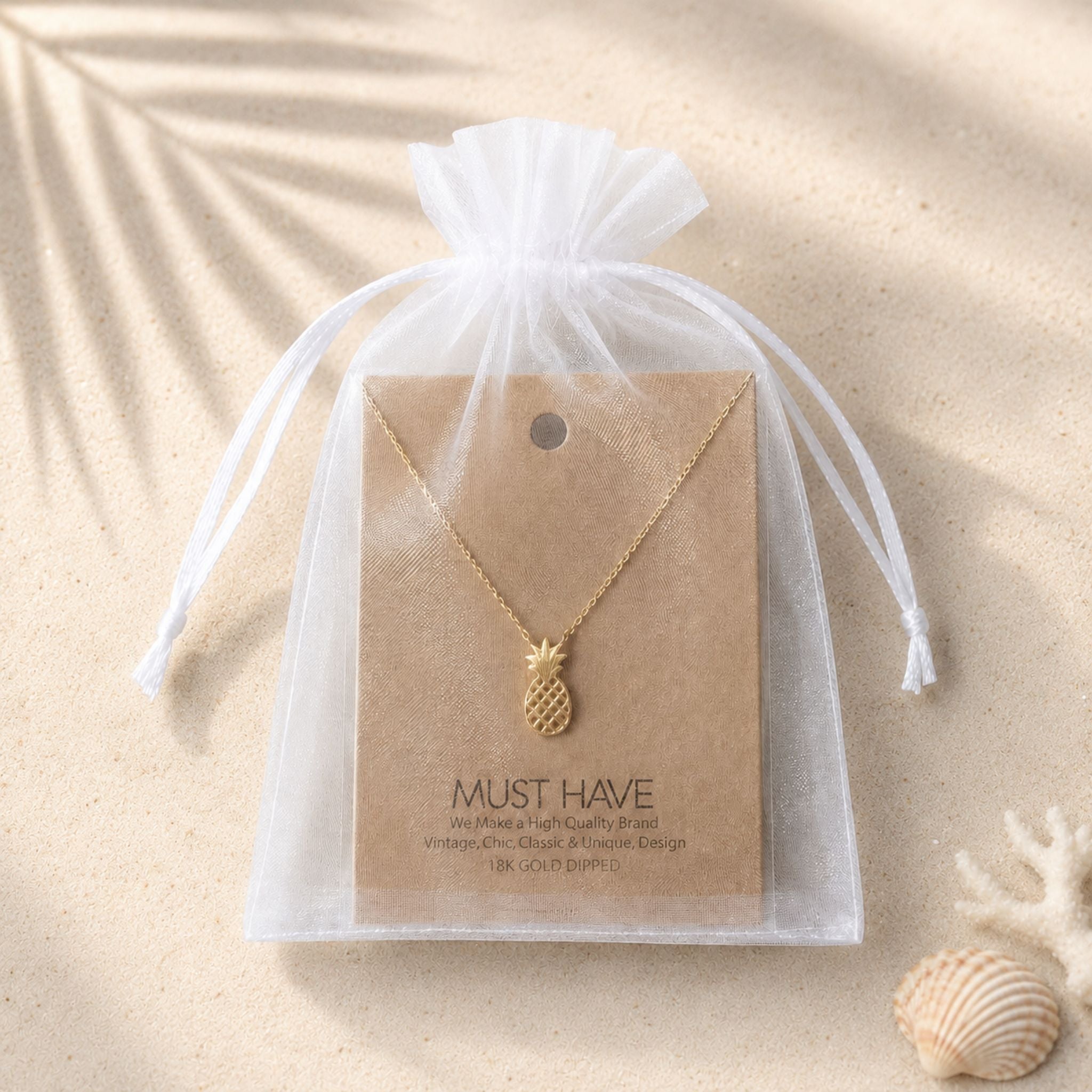 Gold pineapple pendant necklace in an white organza bag for a unique beach lover gift