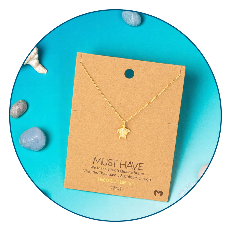 Dainty gold sea turtle necklace styled for everyday wear with ocean-inspired accents.